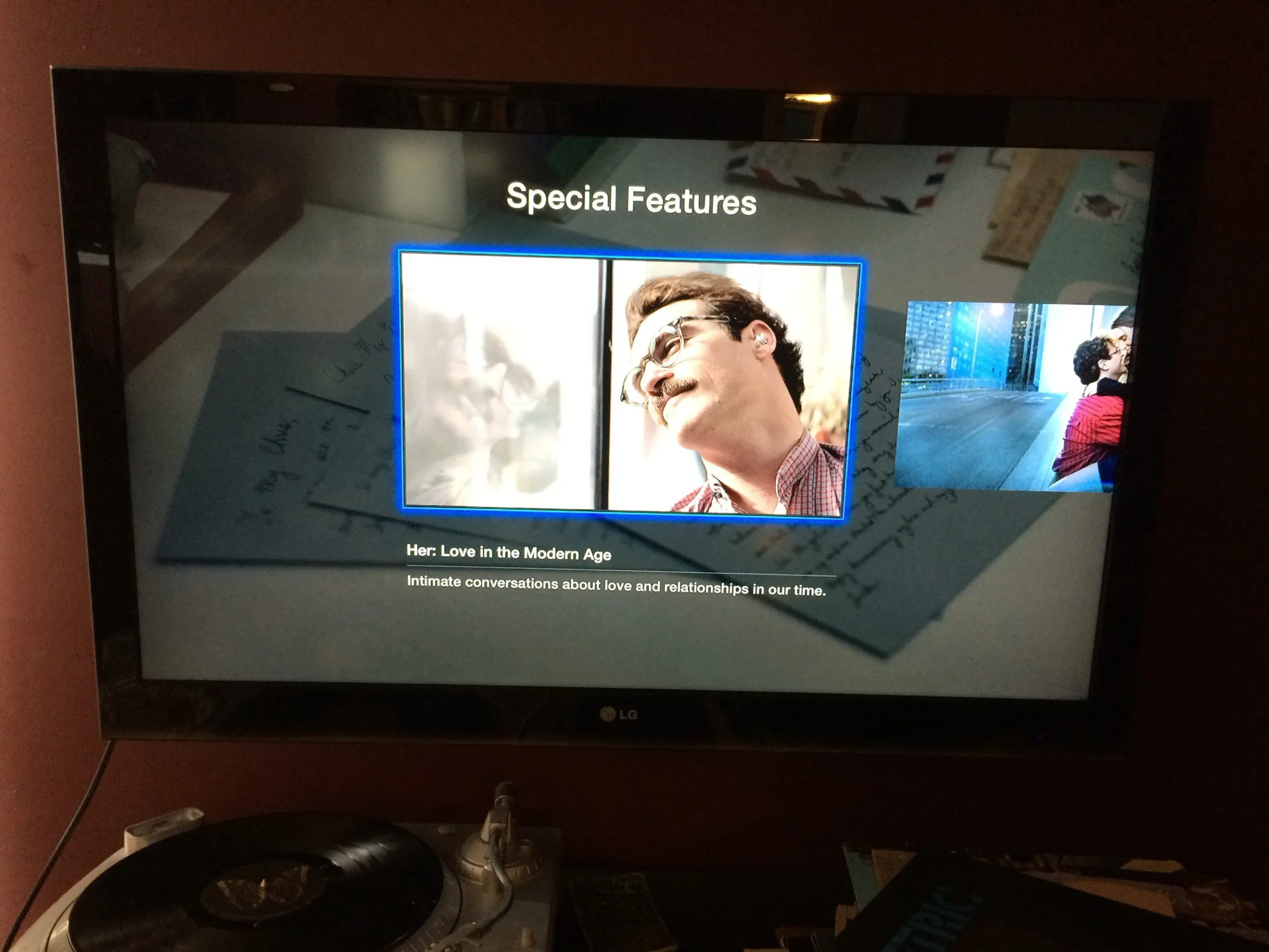 Apple TV displaying the iTunes Extras Special Features menu