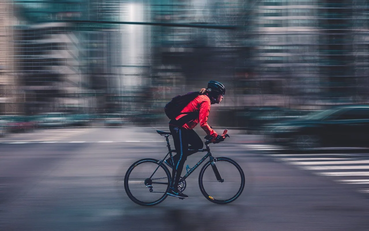 Cyclist riding quickly through a forest, representing location tracking