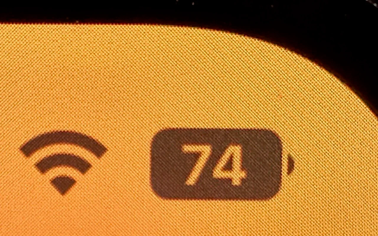 Close-up of an iPhone status bar showing 74 percent inside the battery icon
