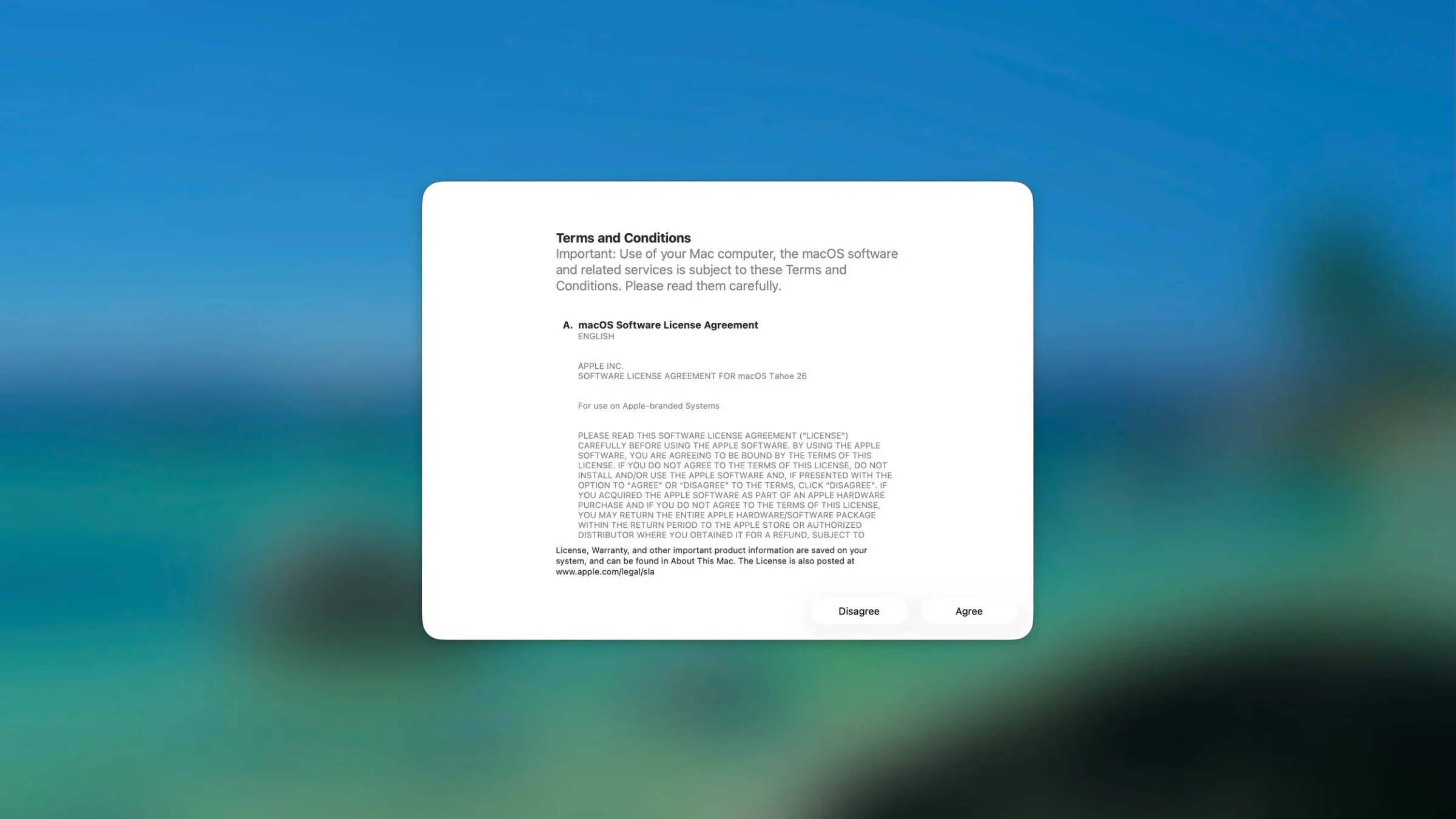 Overlay of the macOS software license agreement on a blue-green blurred background, with 'Disagree' and 'Agree' buttons at the bottom.