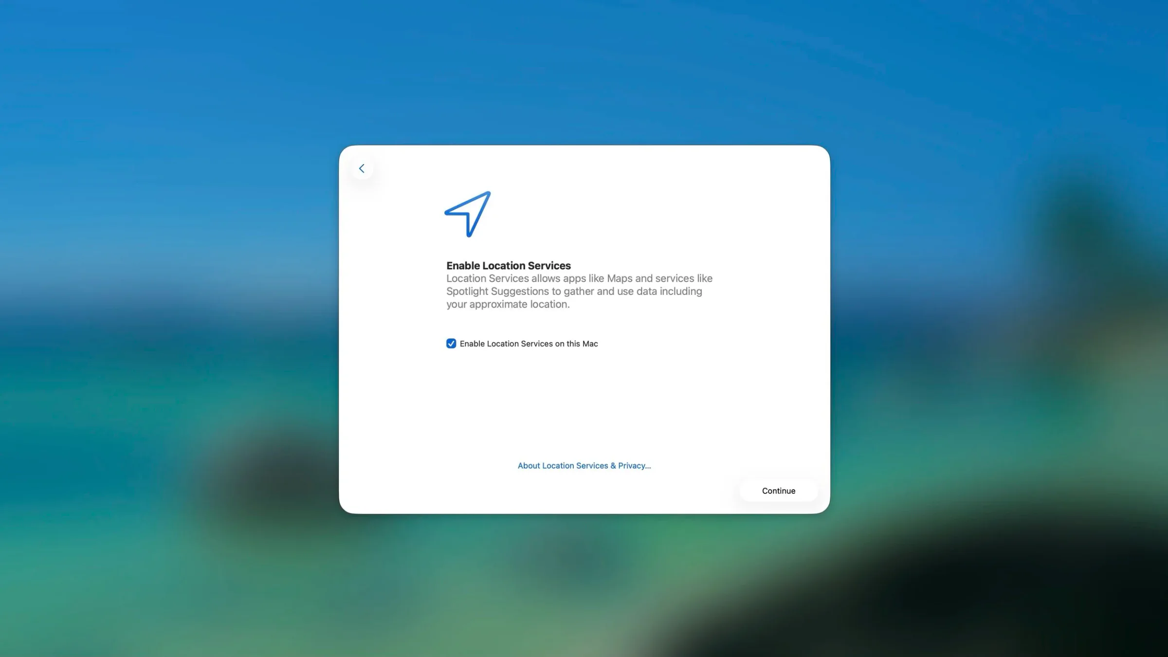A digital screen showing a setup window to enable location services on a Mac, with a toggle checked, a blue paper plane icon at the top, and a 'Continue' button at the bottom.
