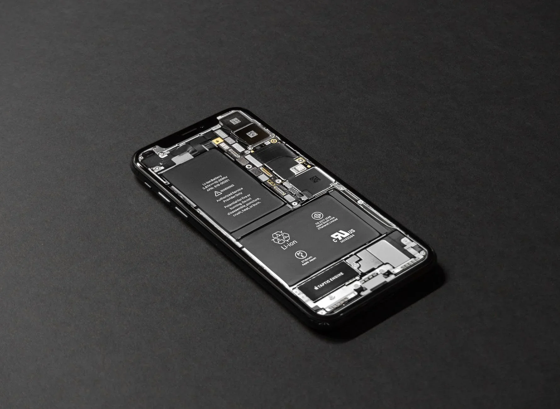 iPhone with its internal battery and components exposed