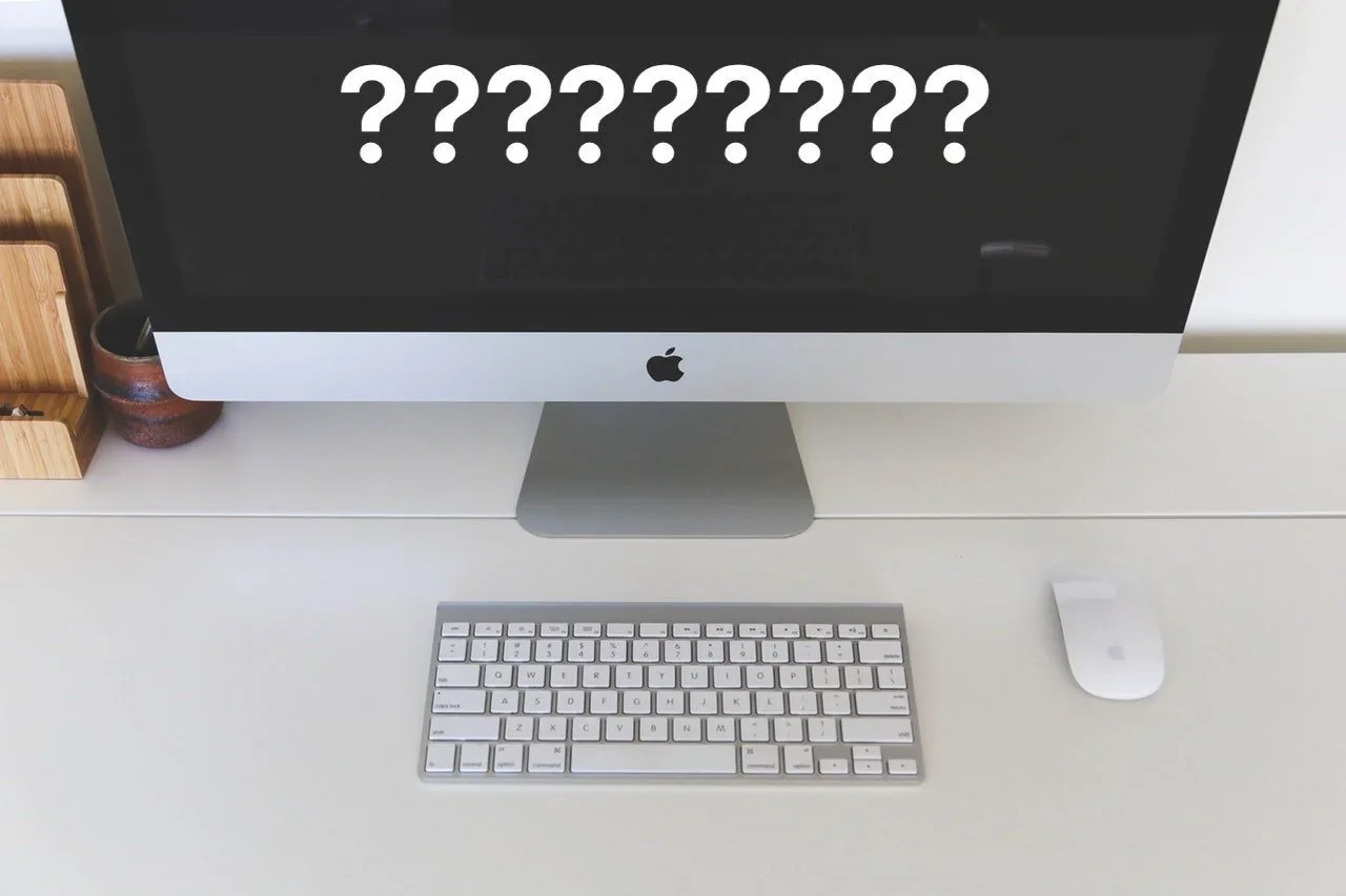 An iMac displaying question marks above its screen