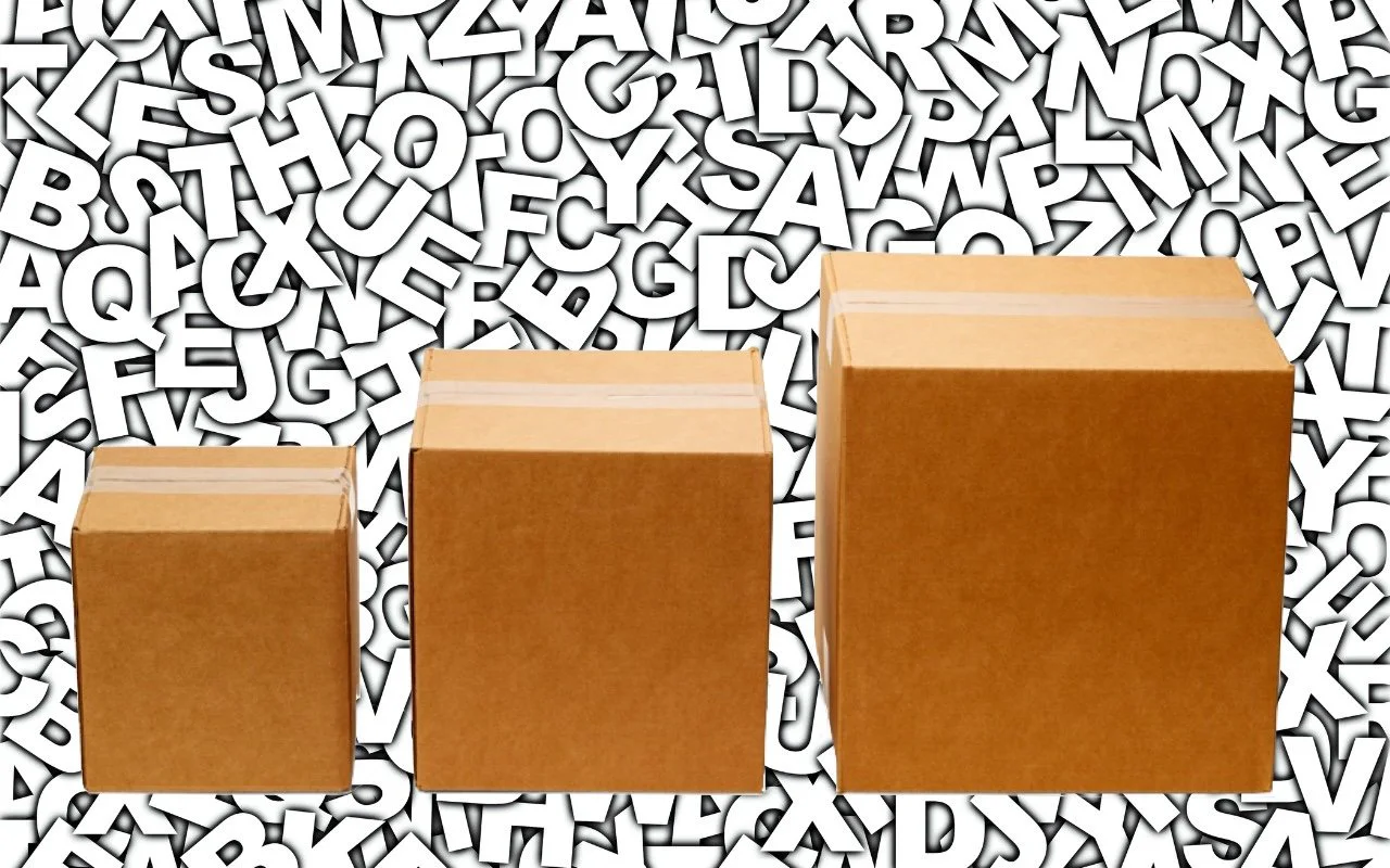 Three cardboard boxes of different sizes against a background of letters