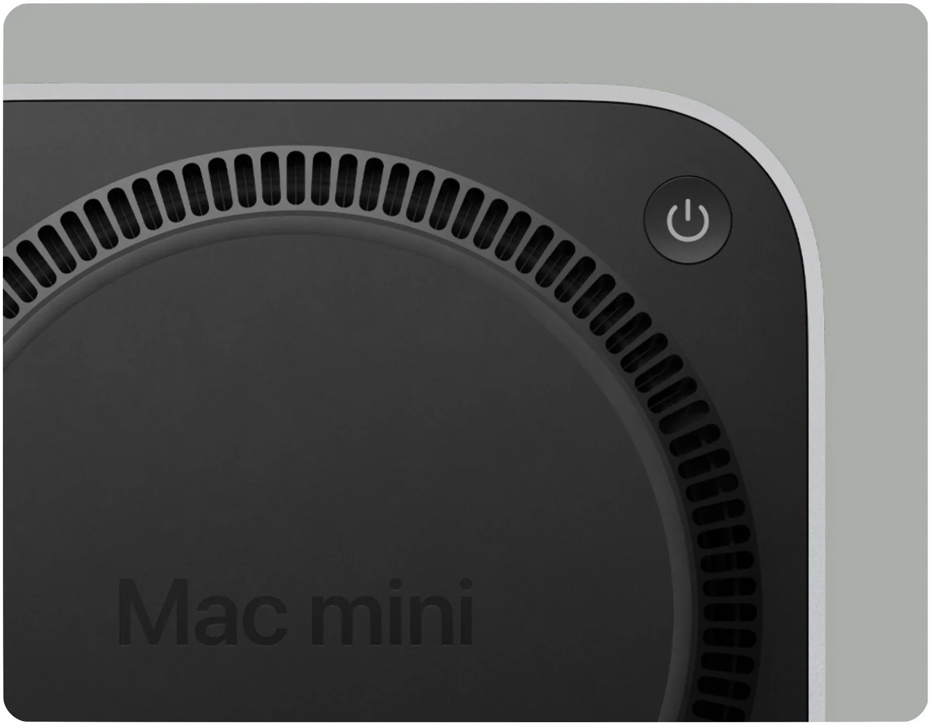 Close-up of the power button on the underside of an M4 Mac mini