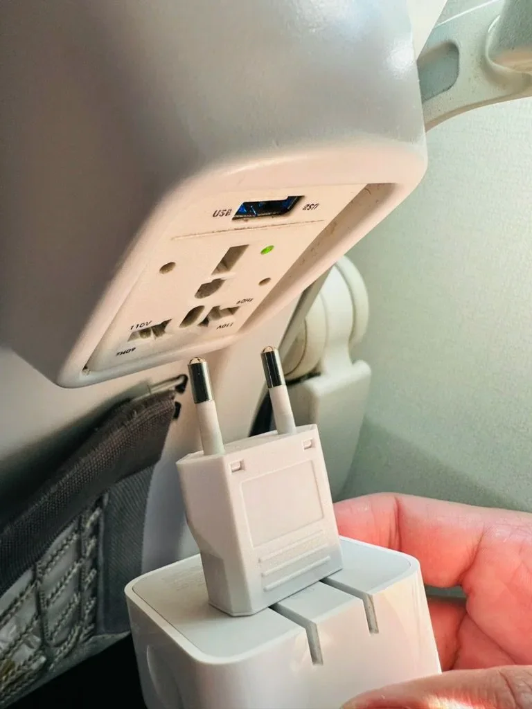 A Europlug adapter being attached to a MacBook Air charger