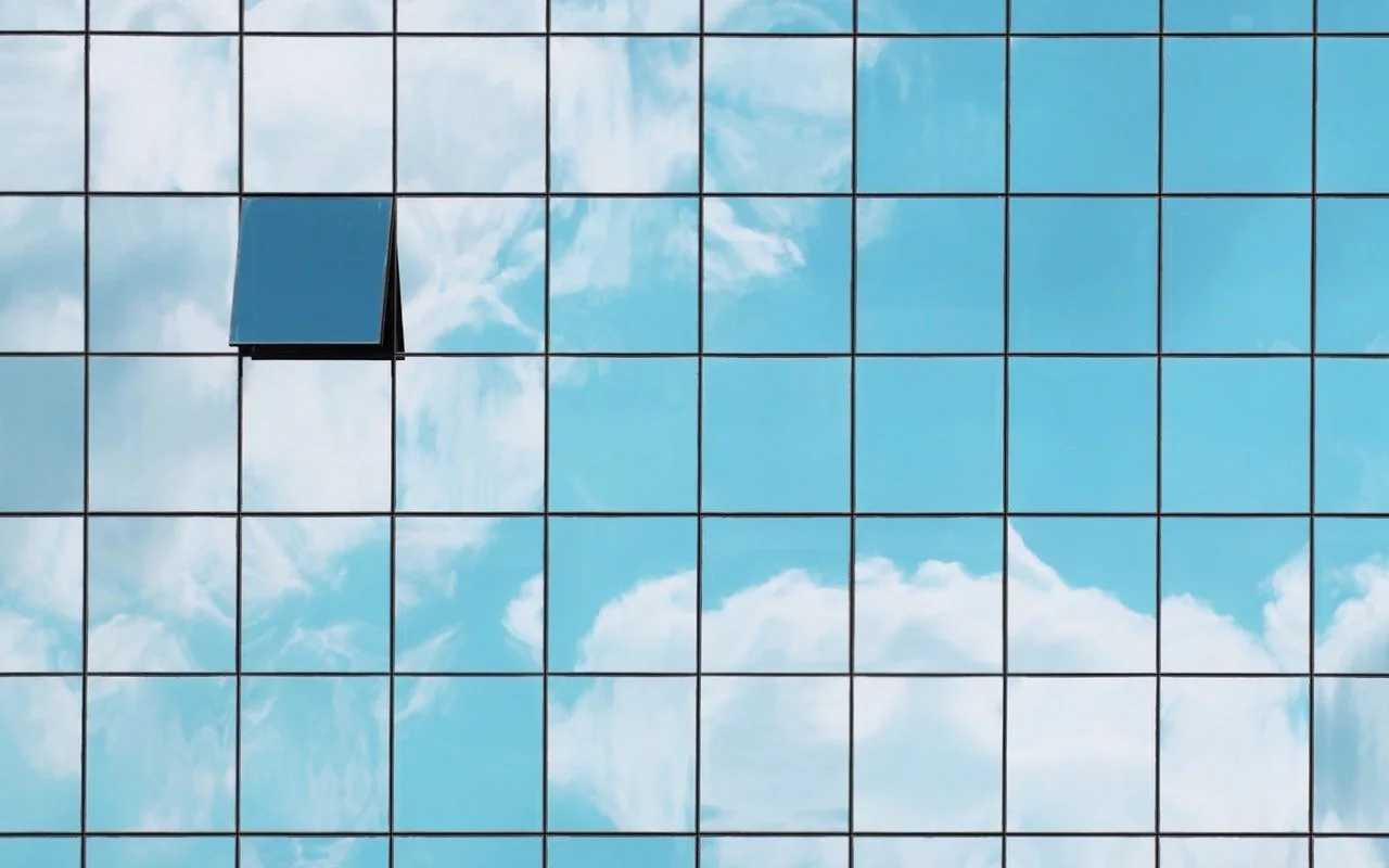 A wall of blue tiles with one dark tile standing out