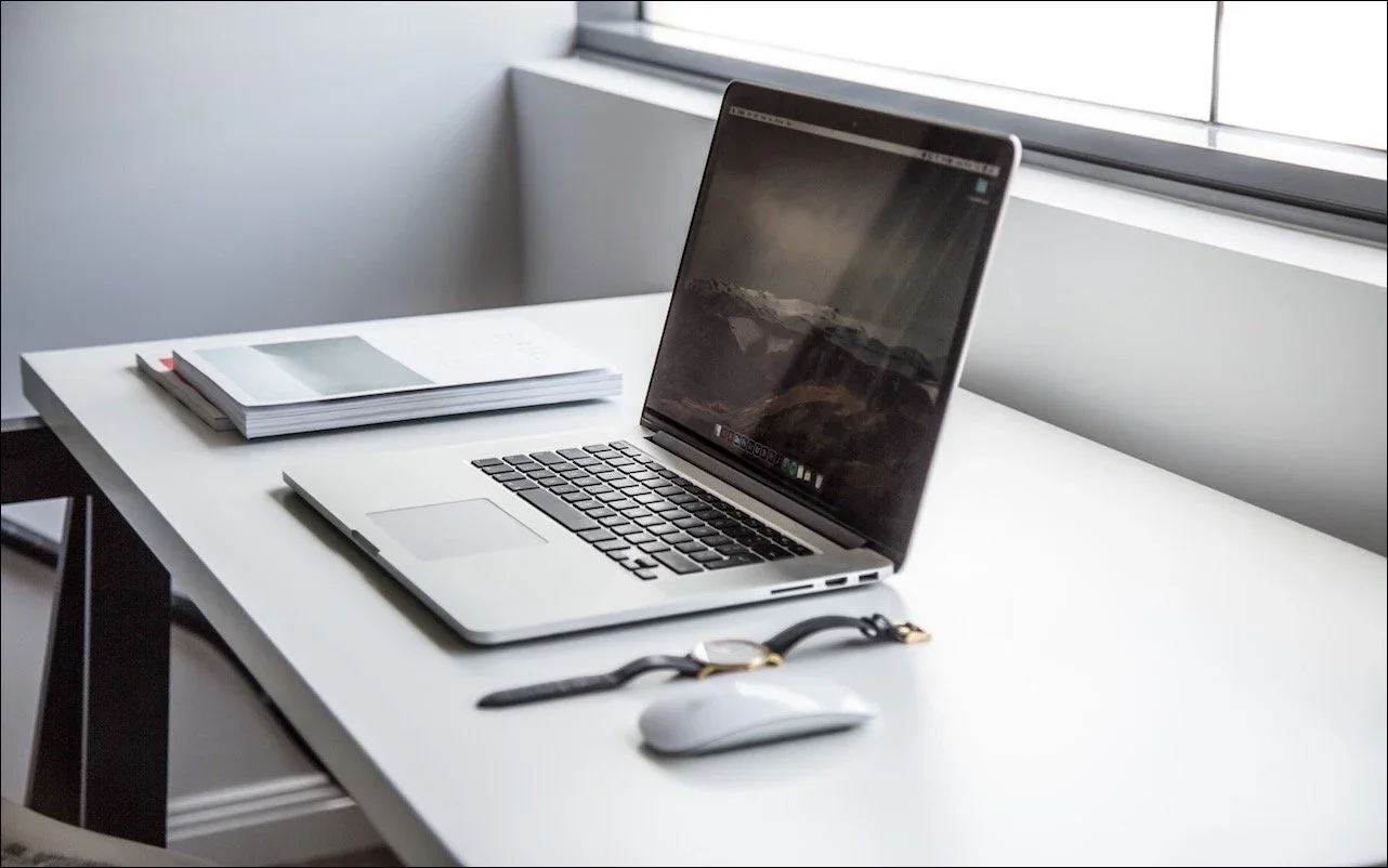 A MacBook on a tidy desk with its desktop visible