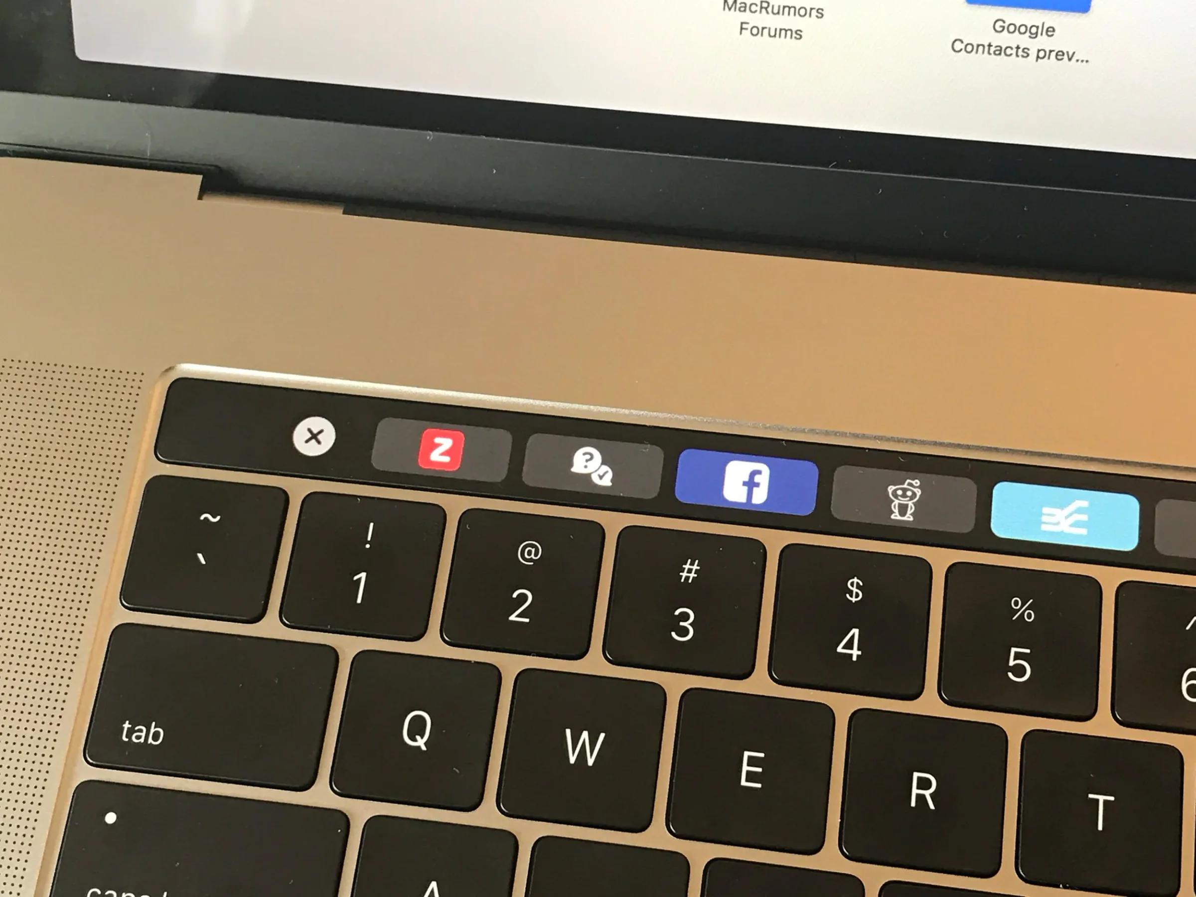 MacBook Pro keyboard with the butterfly keyboard service program page visible above it