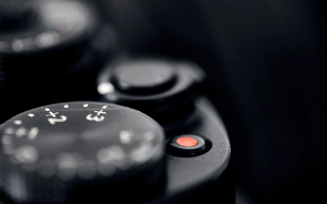 Close-up of a camera shutter button and exposure controls